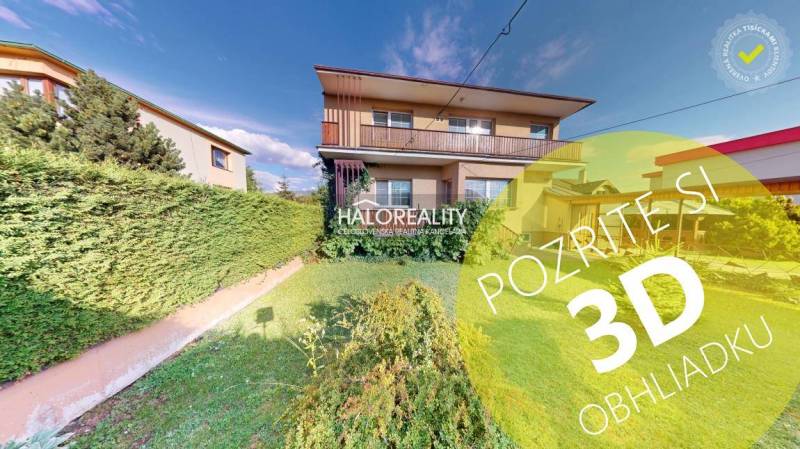 A family house in Krasňany with a front garden and a green hedge.