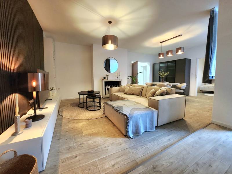 Interior of a 2-room apartment with a wooden decor floor and stylish lighting.