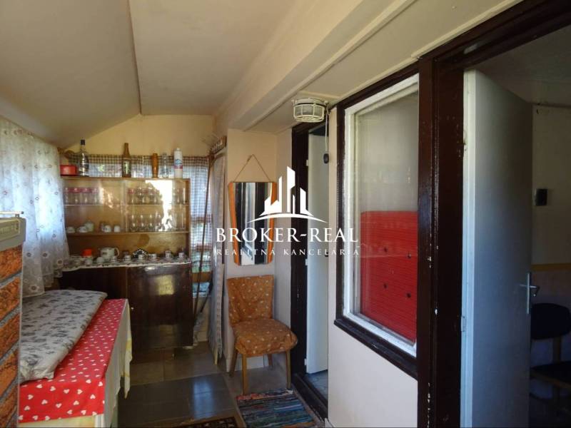 Interior of a family house with older furniture, a bed, and various decorations.