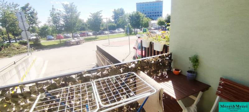 A balcony with a view in Bratislava, Krasňany, next to a 1-room apartment with plants and a drying rack.