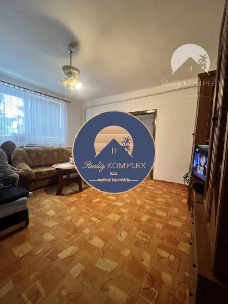 Living room in a family house with a sofa and wooden decor flooring.