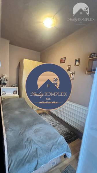 A room with a bed, wardrobe, and decorations, wooden floor decor, family house.