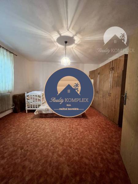 Children's room with carpeted floor, bed, light, and wardrobes in a family house.