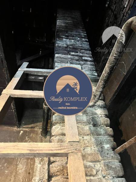 Attic in a family house with a brick wall and beams, Reality Komplex.