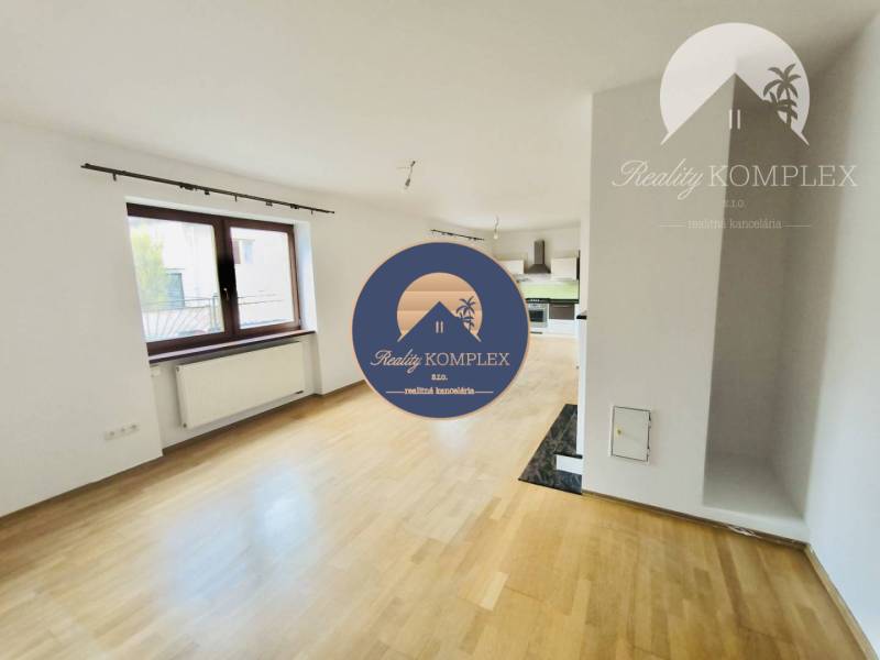 Living room in a family house with a wooden decor floor and a large window.