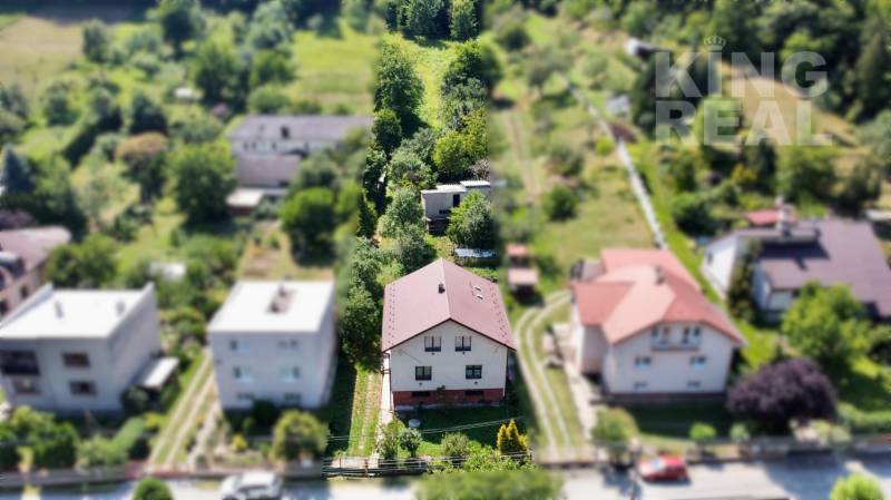 A family house at Dúbravská 58 in Prešov surrounded by a garden and vegetation.