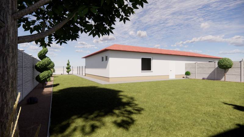 A family house in Zemianska Olča with a grassy yard, trees, and a fence around the garden.