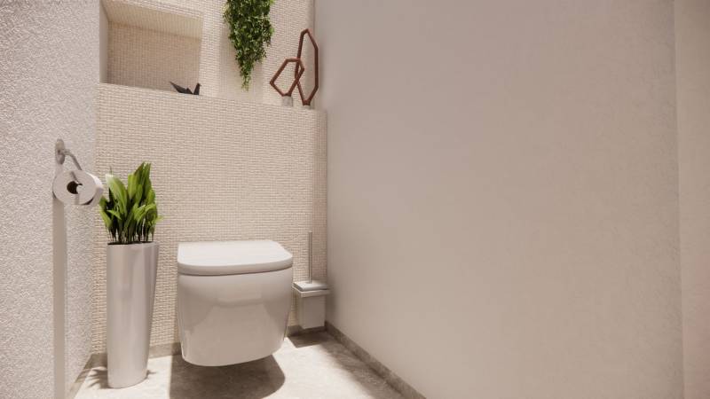 A bathroom in a family house with white sanitary ware, decorative greenery, and light-colored walls.