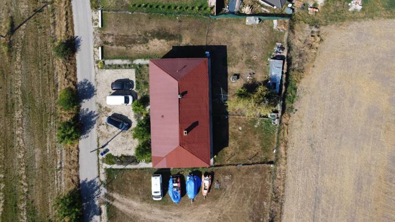 Aerial view of a family house in Zemianska Olča with a shelter and parking lot.