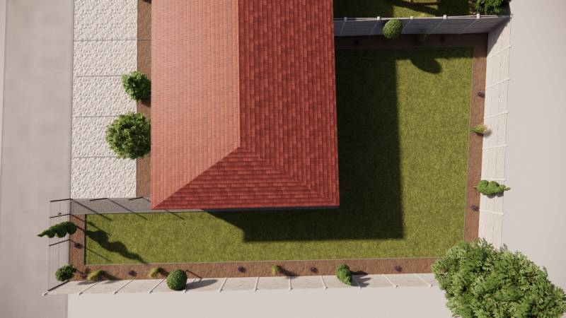 A family house in Zemianska Olča with a red roof and a landscaped garden.