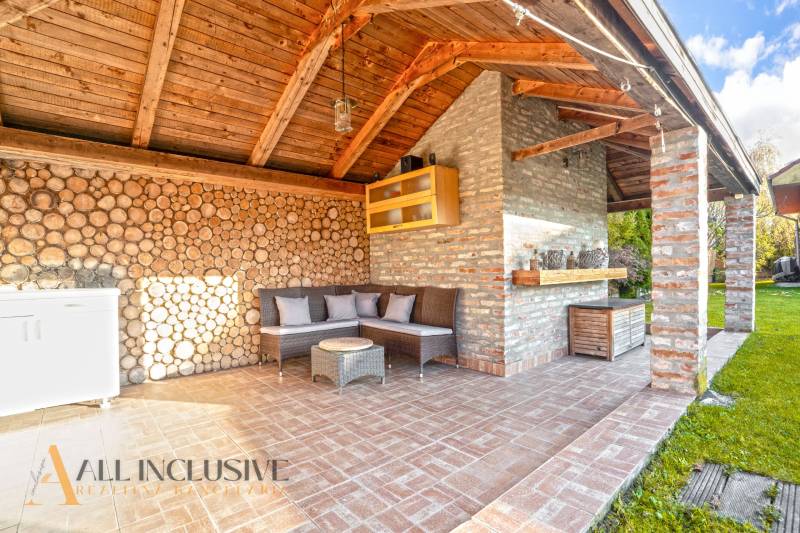 Exterior of a family house in Dobrohošť with a seating area and brick walls.