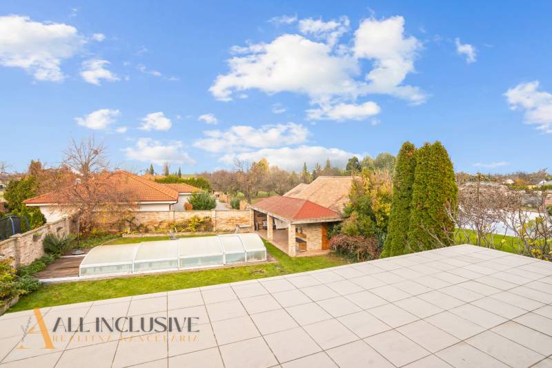 A view of the garden with a covered pool and a gazebo in a family house in Dobrohošť.