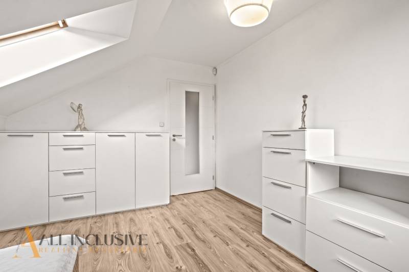 Interior of a family house with white furniture and a wooden decor floor.