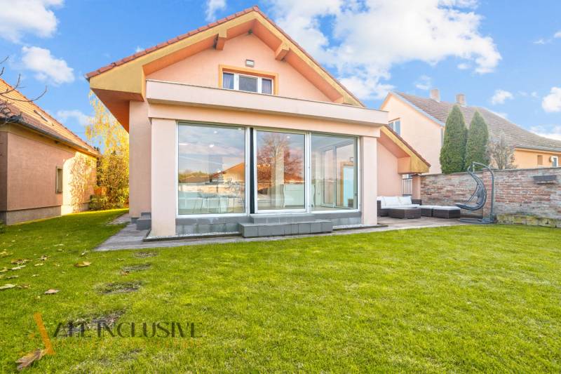 A family house in Dobrohošť with a spacious green garden and a glass terrace.