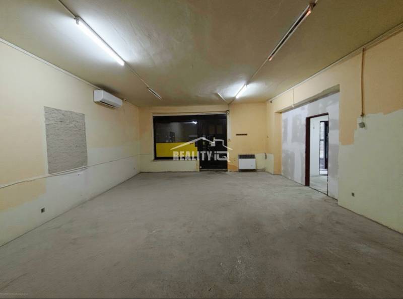 A spacious room in a family house with lighting and air conditioning.