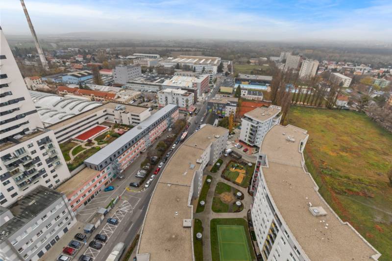 Aerial view of Petržalka in Bratislava with residential buildings and a playground.