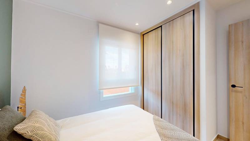 Recreational apartment with a bed, wardrobe, and floor with wooden decor.