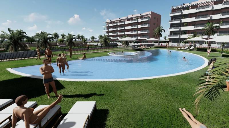 A holiday apartment in El Raso with a pool surrounded by palm trees and relaxing people.
