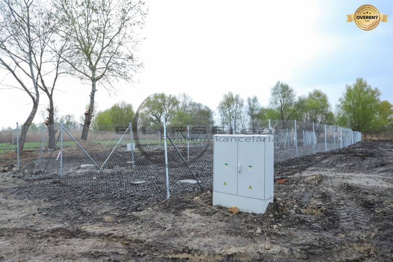 Building plot on Nad potokom street in Zohor, fenced with wire mesh.