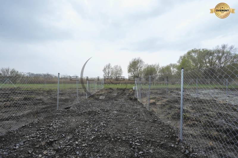 A fenced plot of land on Nad potokom Street in Zohor for residential purposes.
