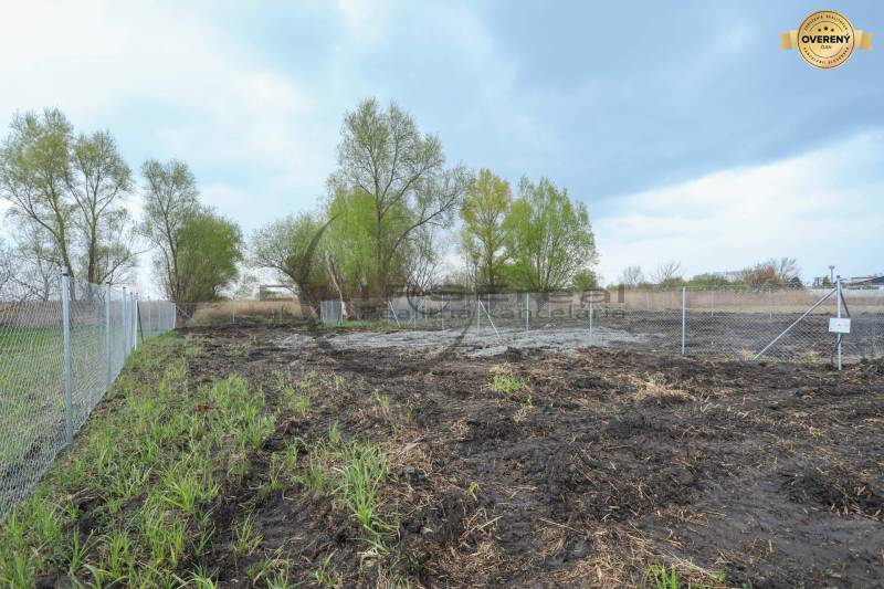Plots - living near the street Nad potokom in Zohor with fencing and trees in the background.