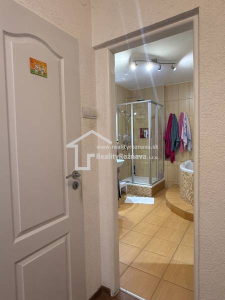 A bathroom in a 3-room apartment with ceramic tiles and a shower corner.