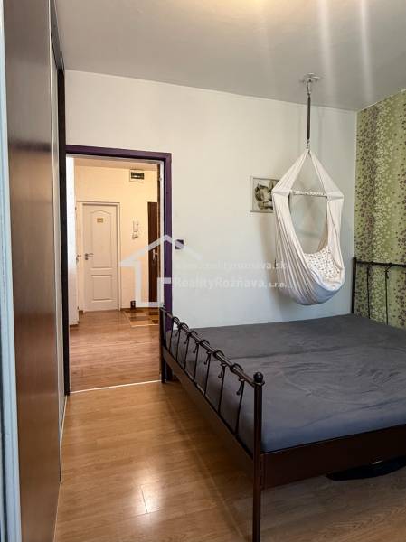 Bedroom with a hanging chair and a bed, floor with wood decor, 3-room apartment.