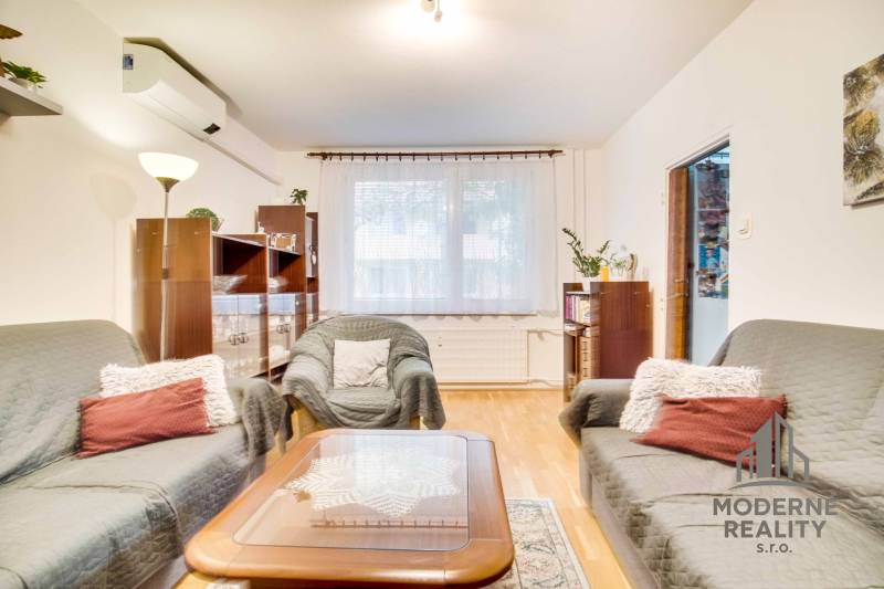 Living room in a 3-room apartment with comfortable sofas and a floor with a wooden decor.