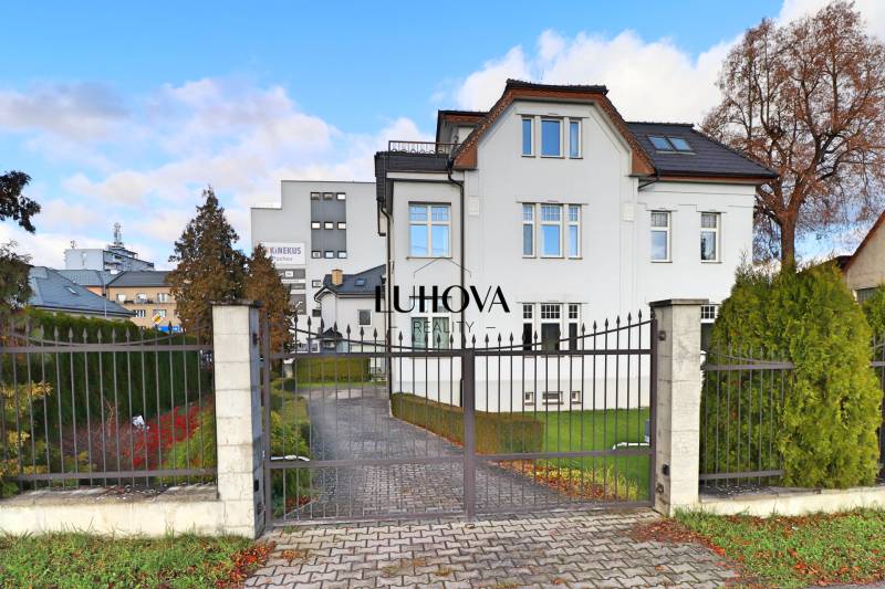 House with a lawn and a fence on Nábrežie slobody street in Púchov.