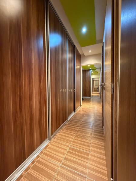 A hallway with cabinets and a floor with a wooden decor in a 3-room apartment.