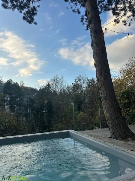 A pool on the terrace with a view of the trees at a 3-room apartment on Dolná in the Old Town.