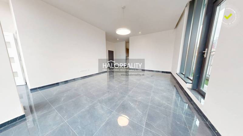 Offices with large windows and glossy tiles, part of the space for rent.