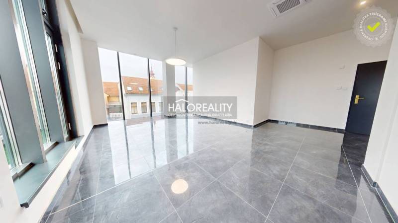 Spacious offices with large windows and ceramic tile flooring.