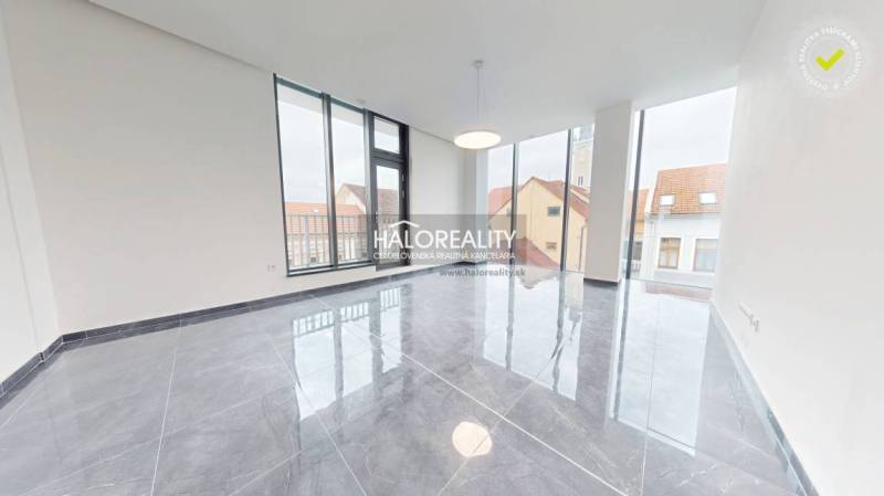 A spacious office with large windows and a shiny stone floor in Rimavská Sobota.
