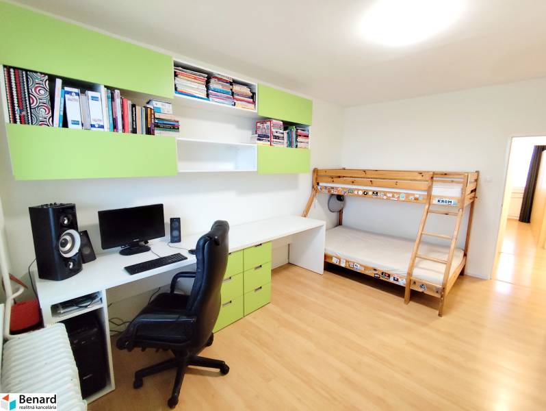 Children's room with a bunk bed, desk, and shelves in a 3-room apartment.
