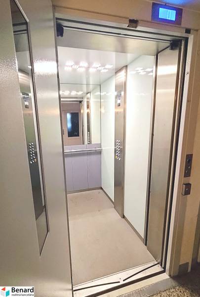 Open elevator with an internal mirror and lighting in a 3-room apartment.