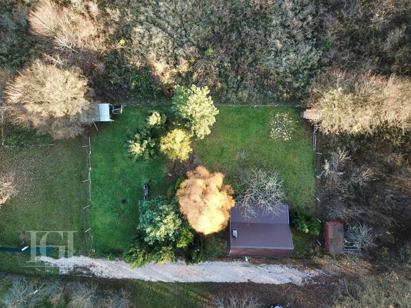 Aerial view of the Cottage in Štitáre, surrounded by greenery and trees.