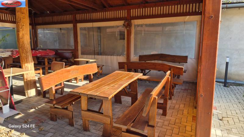 Wooden benches and tables in commercial spaces on Park and Main Street in Veľké Ludince.