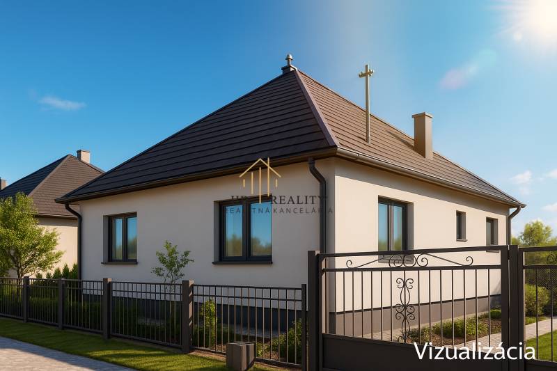 A family house in Hokovce with a classic gable roof and a metal fence in the front garden.