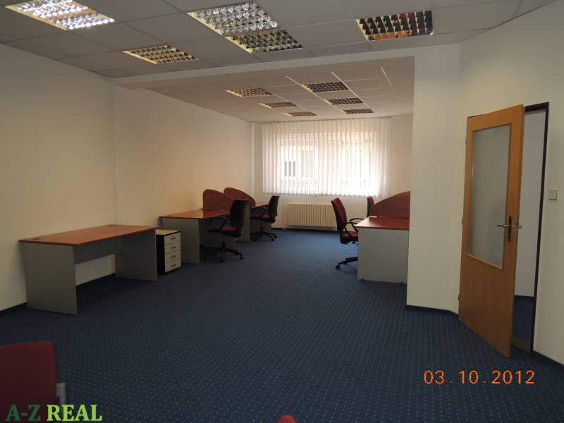 Offices with carpeted floors, desks, and swivel chairs.