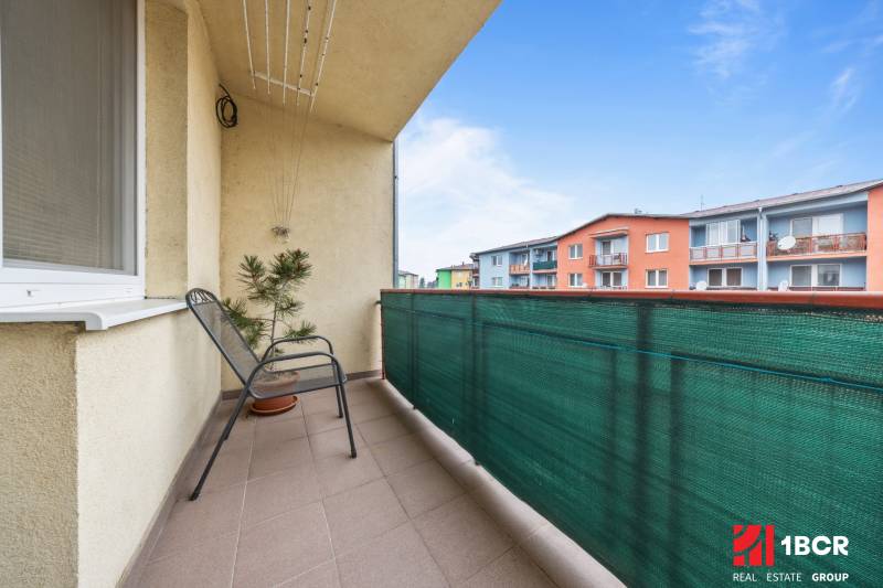 Balcony at a 2-room apartment on Veltlínska Street in Pezinok with a view of colorful buildings.