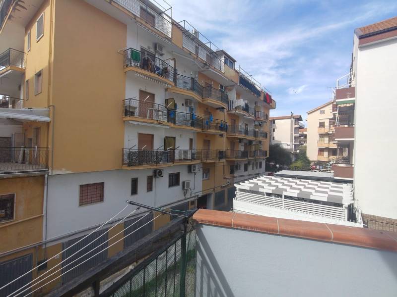 View of apartment buildings on 1 Maggio Street in Scalea from the balcony of a 2-room apartment.