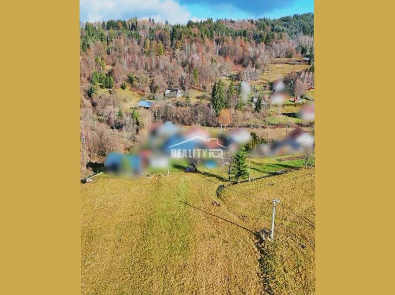 Plots - housing in Turzovka, surrounded by hills and trees.