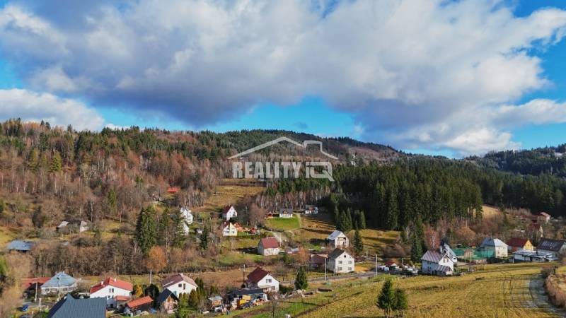 Turzovka offers residential plots with views of wooded hills and houses.
