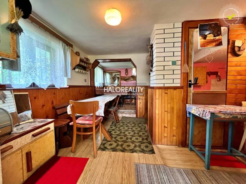Interior of a cabin with wooden decor and a dining table.