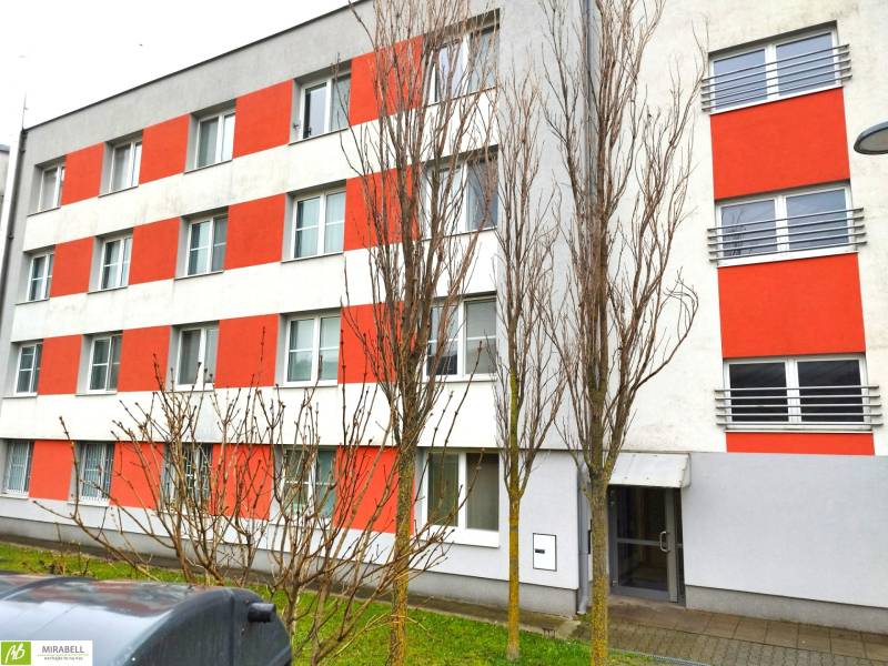 An apartment building with orange accents located on Podbrezovská Street in Bratislava - Rača.