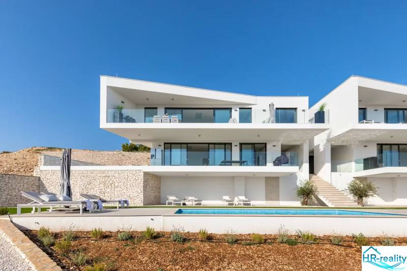 A holiday apartment in Rogoznica with a garden, terrace, and sun loungers by the pool.