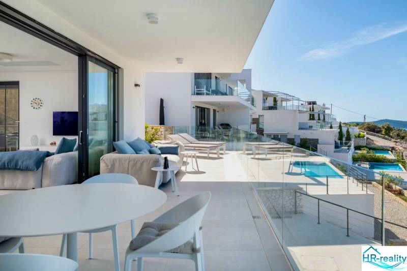 The Recreational Apartment in Rogoznica includes a terrace with a view of the pool and the sea.