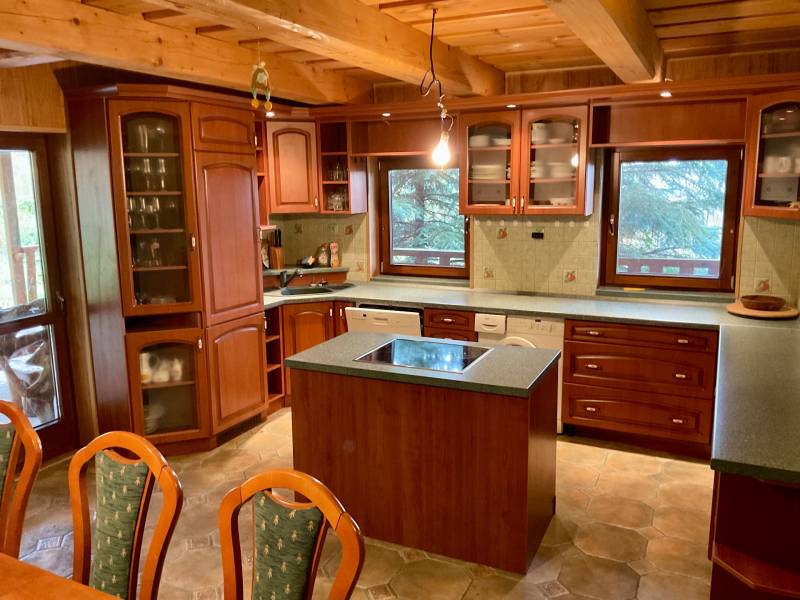 Wooden cladding, wood-decor flooring, kitchen unit and island, recreational plots.