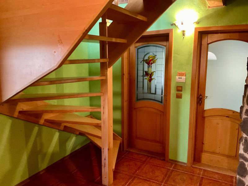 The staircase next to the stained glass door, the walls are light green, recreational grounds.
